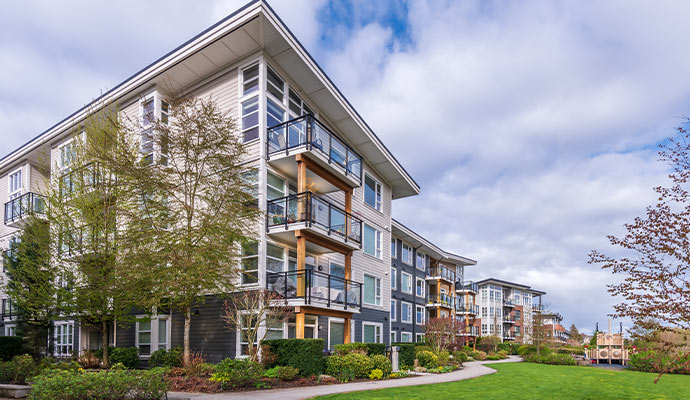 A corner view of a multi-story modern apartment building