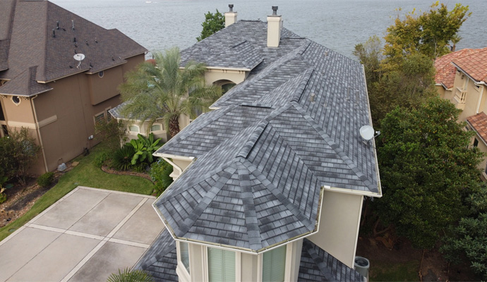 Aerial view of a luxury residential home with a complex roof structure