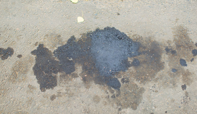 Concrete surface with visible chemical spill stain