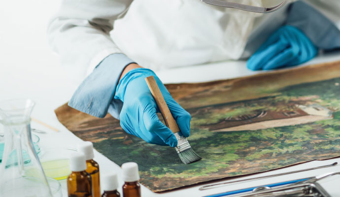 A person restoring a painting