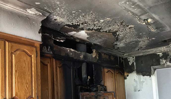 Fire damaged ceiling and drywall in the kitchen