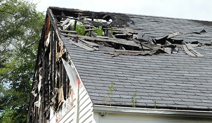 Fire damaged roof and siding of residential house