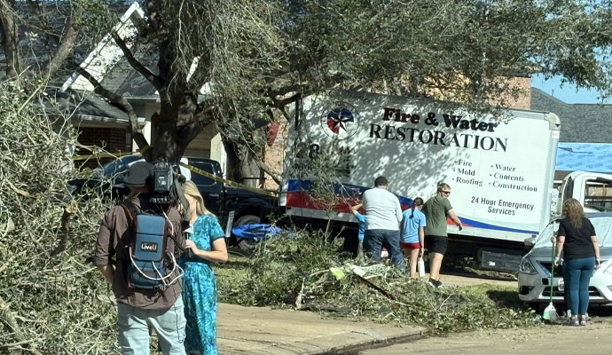 Service vehicle of Fire Reconstruction Inc. standing near a storm damaged property