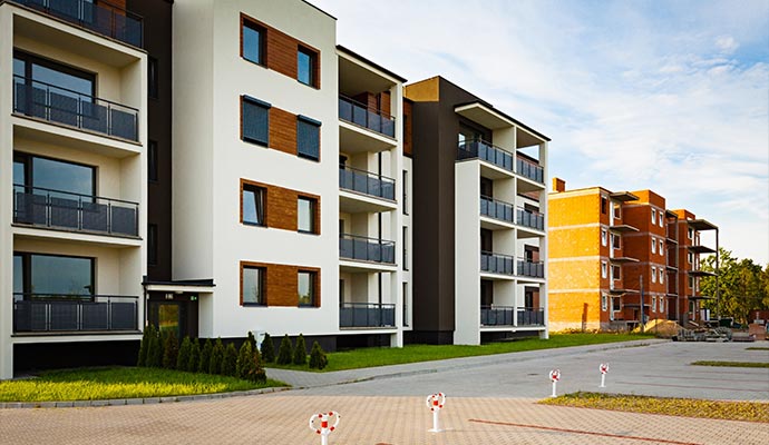 A row of modern four-story condominium buildings