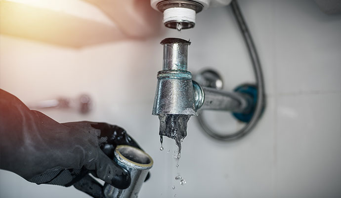 Professional cleaning clogged sink pipe