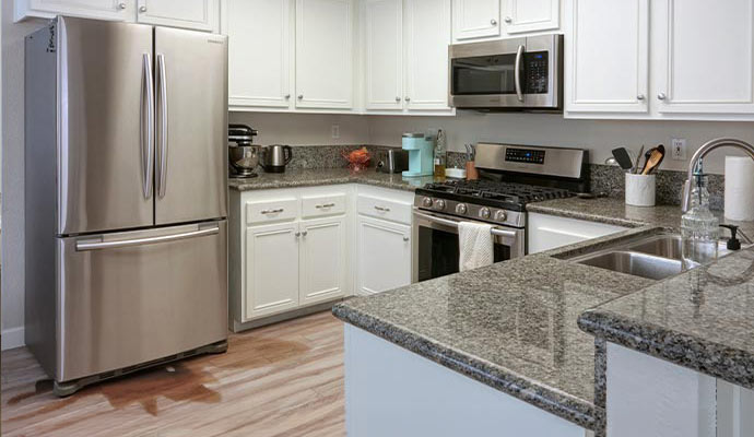 Water damaged kitchen floor due to water leak from refrigerator