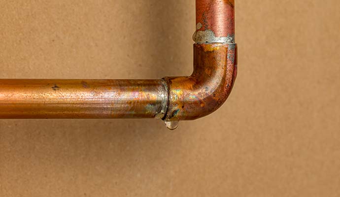 Water dripping from a copper pipe joint